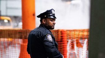 A police officer looking out over a foggy city street.