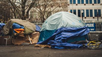 Tents for homeless people on the side of a street.