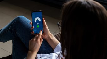 Woman sitting down and looking at her phone.